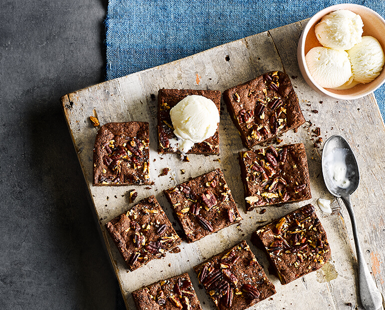 hazelnut brownies cut into squares with vanilla ice cream